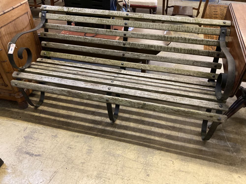 A wrought iron slatted wood garden bench, width 150cm, depth 66cm, height 71cm